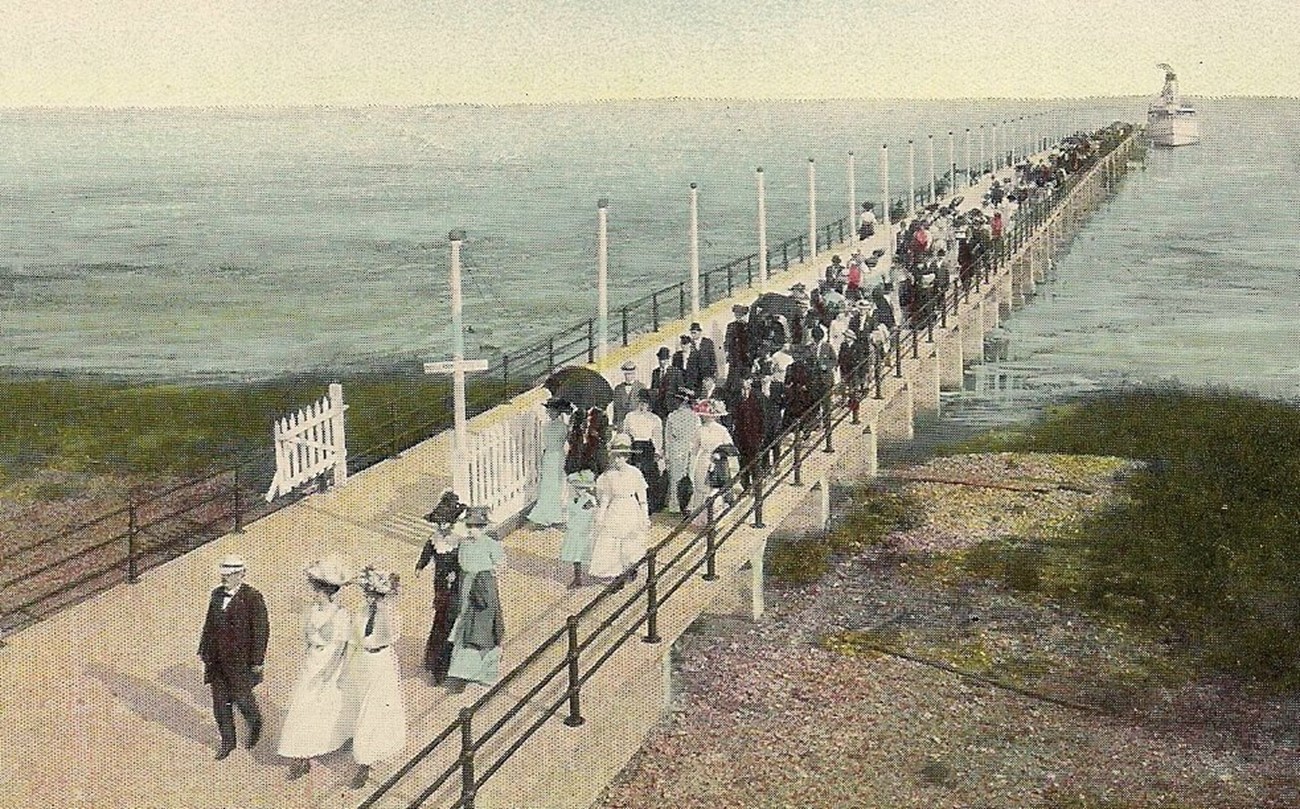 A drawing of a large crowd of people walking on a peer.